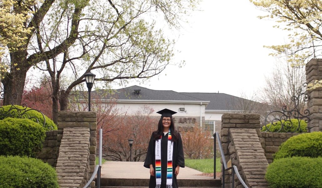 A Person Standing In Front Of A Tree