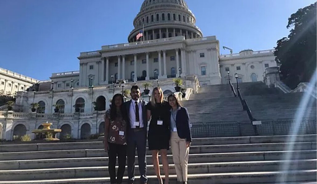 A Group Of People Standing In Front Of A Building